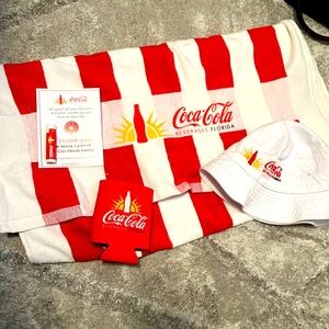 Coca Cola pack towel, bucket hat, chapstick, beer coozy .
